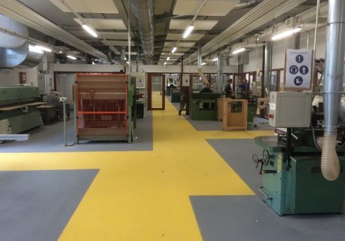 Factory floor with grey and yellow tiles