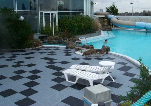 Grey and black open floor tiles around a pool area
