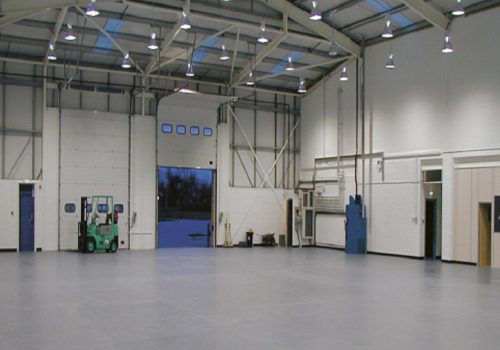 Large empty warehouse with grey floor tiles