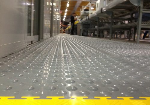 Close up of grey studded Flexi-Tile with yellow ramp