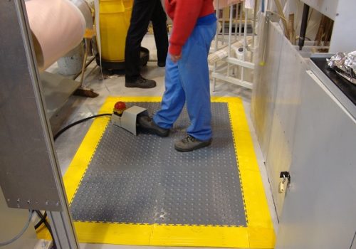 Grey studded tiles with yellow ramps