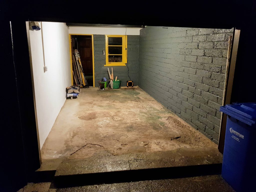Empty garage with cracked concrete floor